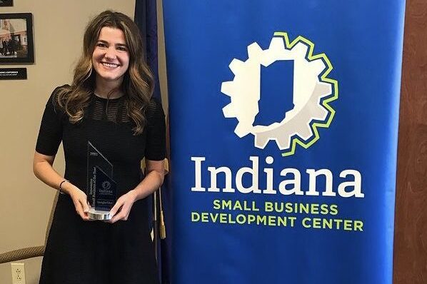 Anna Haldewang holding an Award